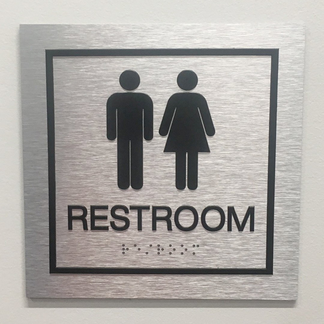 unlocking accessibility with tactile ada restroom sign