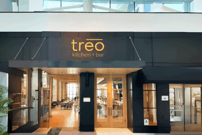 Professional installer completing corporate signage installation on a modern office building exterior for All Star Signs