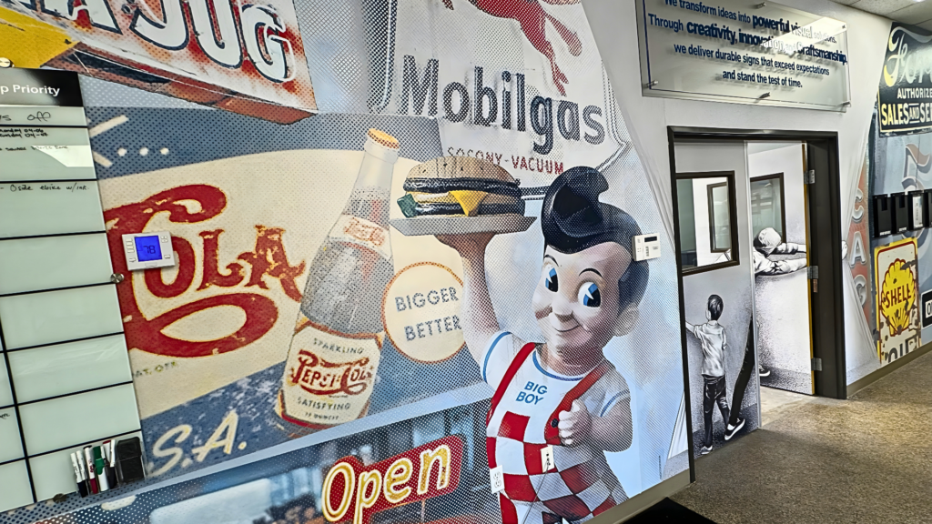 Custom wall mural installation featuring retro diner graphics and branded visuals inside a commercial space in San Diego