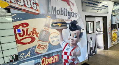Custom wall mural installation featuring retro diner graphics and branded visuals inside a commercial space in San Diego