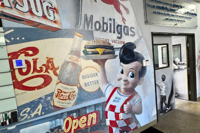 Custom wall mural installation featuring retro diner graphics and branded visuals inside a commercial space in San Diego
