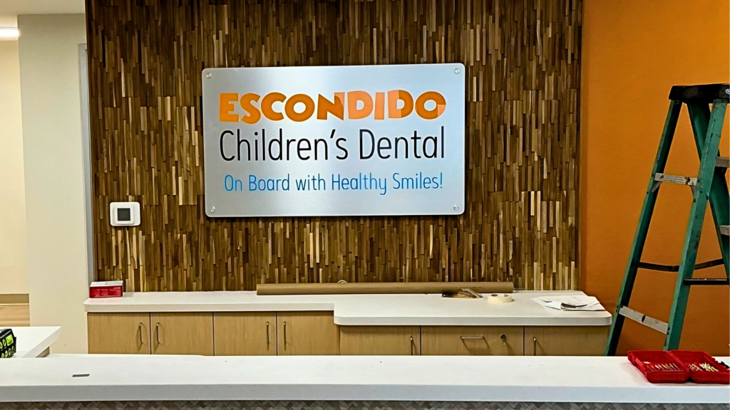 Professional interior lobby sign installation at a dental office in Escondido, California by All Star Signs.