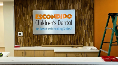 Professional interior lobby sign installation at a dental office in Escondido, California by All Star Signs.