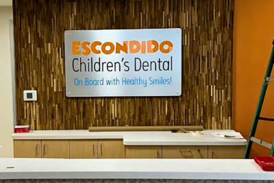 Professional interior lobby sign installation at a dental office in Escondido, California by All Star Signs.