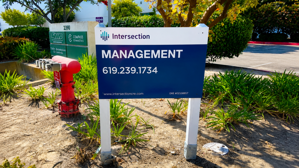 Property management sign in San Diego featuring Intersection Management branding and contact information
