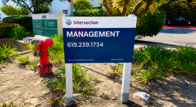 Property management sign in San Diego featuring Intersection Management branding and contact information