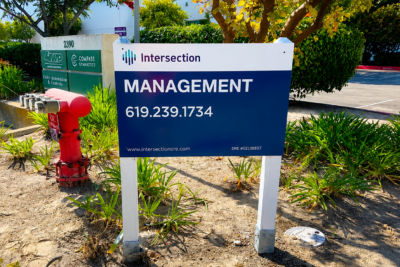 Property management sign in San Diego featuring Intersection Management branding and contact information