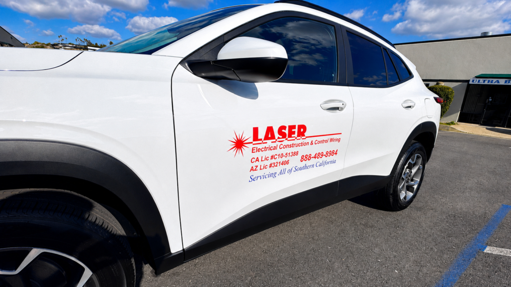 Vehicle graphics in San Diego featuring branded business lettering on a white company vehicle