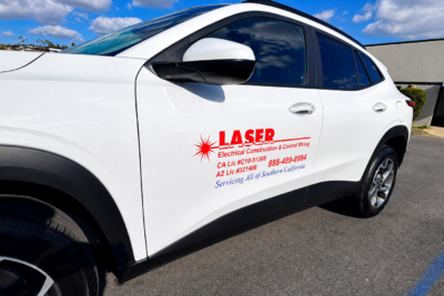 Vehicle graphics in San Diego featuring branded business lettering on a white company vehicle