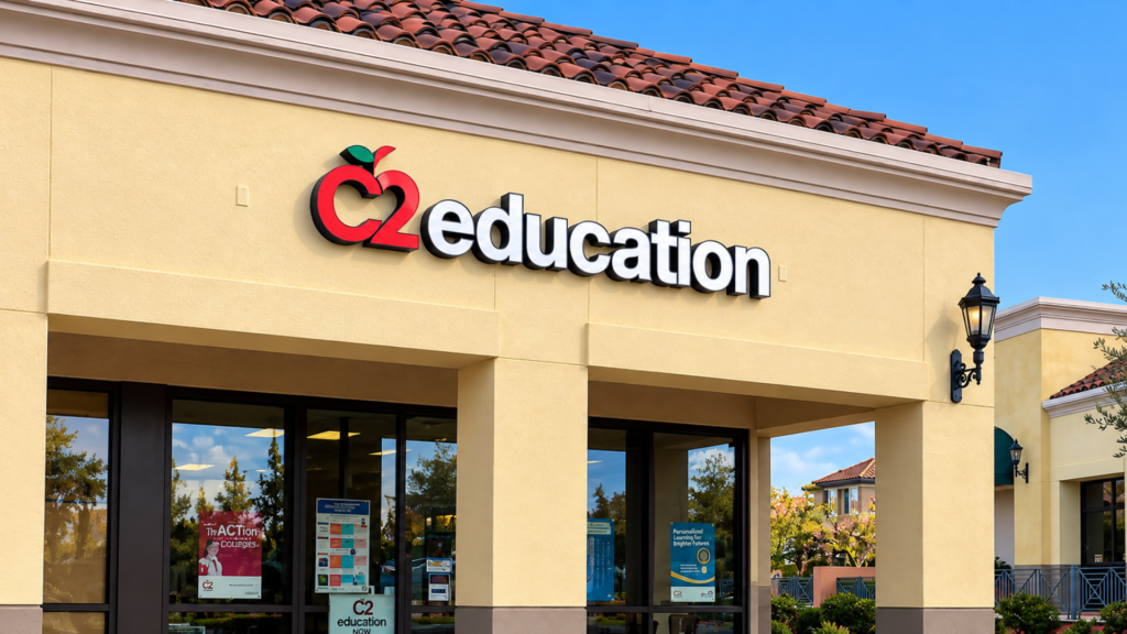 C2 Education storefront featuring red and white dimensional channel-style lettering mounted above the entrance of a commercial building